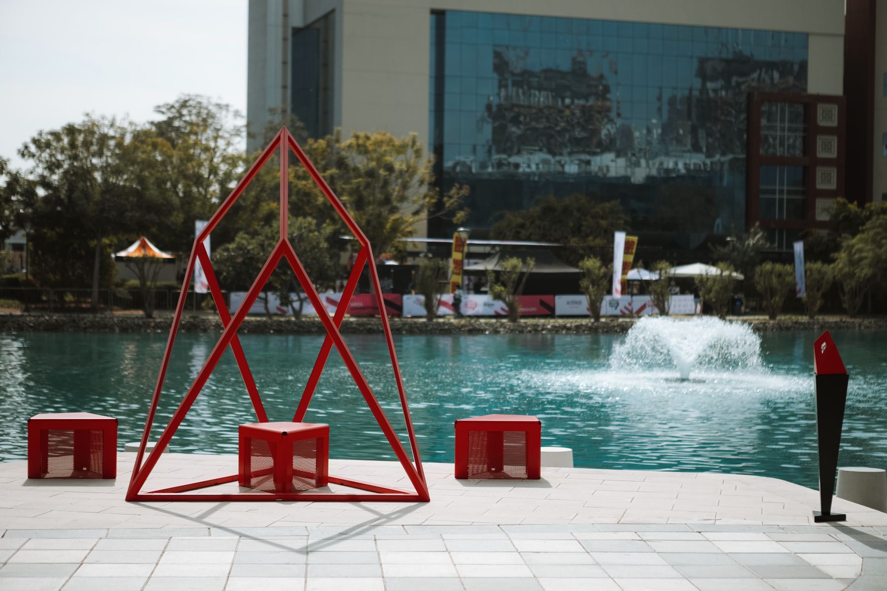 The Chestahedron sculpture in Signal Red at Dubai Internet City, with Building 2 behind