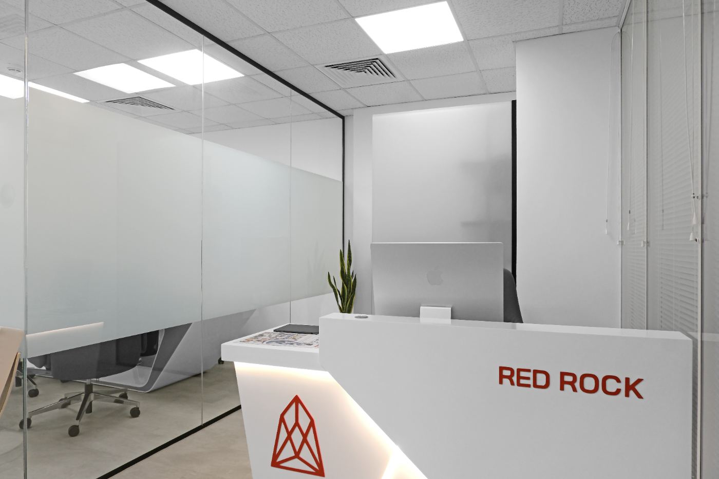 Red Rock reception desk with symbol and wordmark
