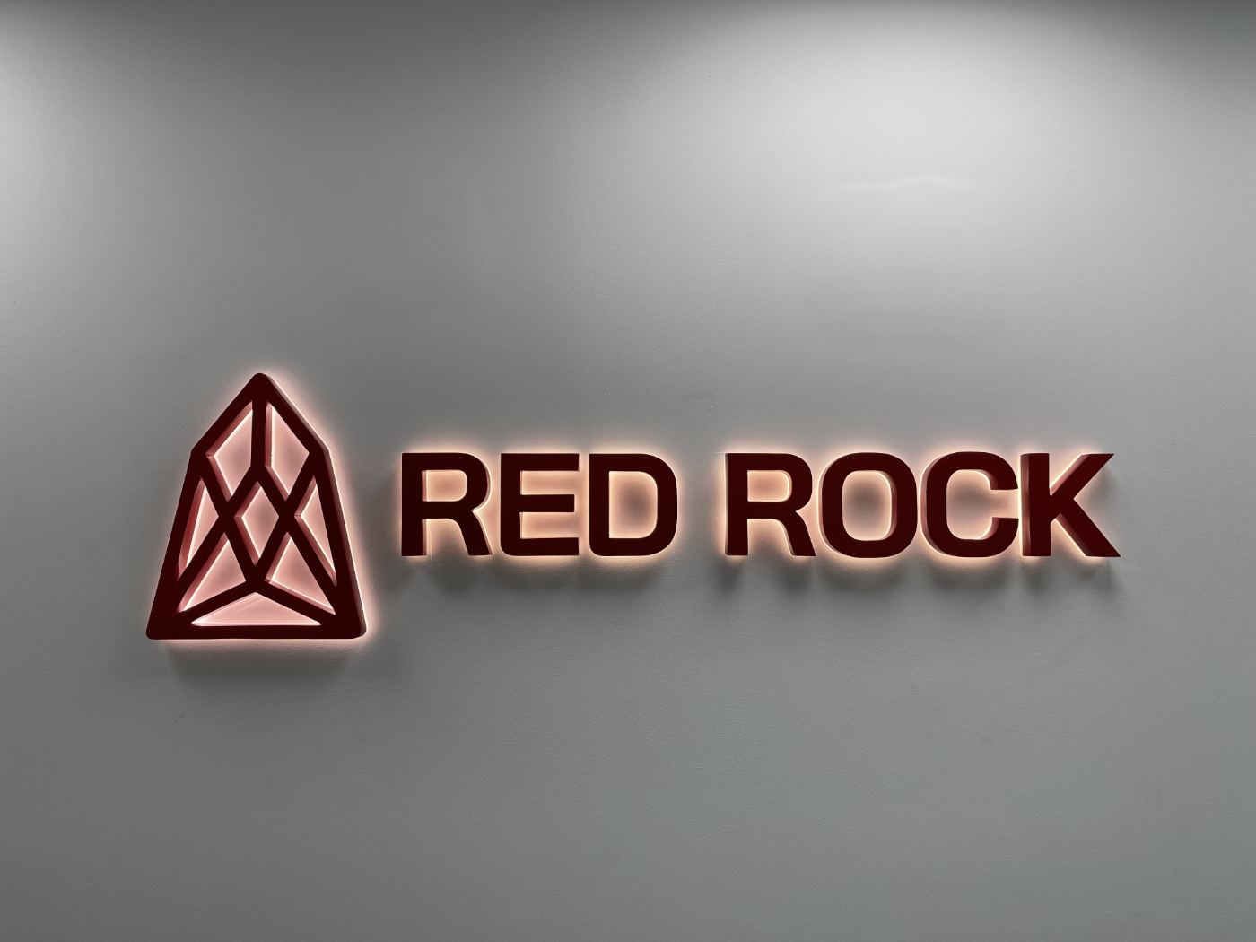 Backlit Red Rock sign on the office wall, Office 310